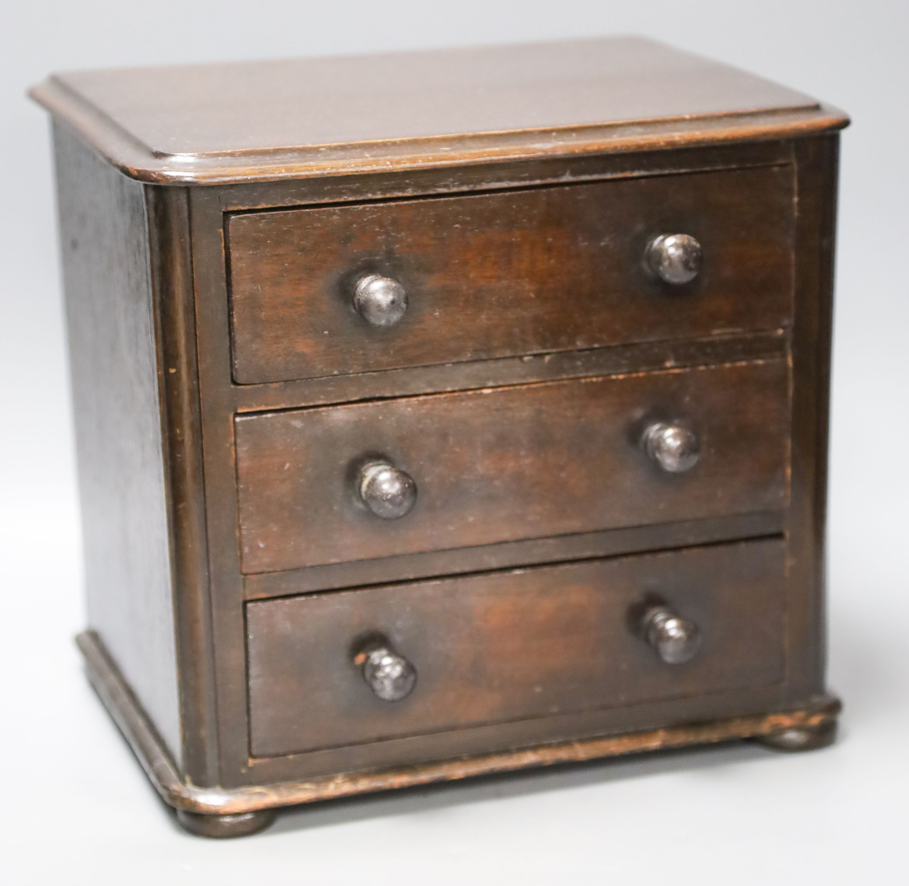 A Victorian miniature mahogany chest of 3 drawers 27cm